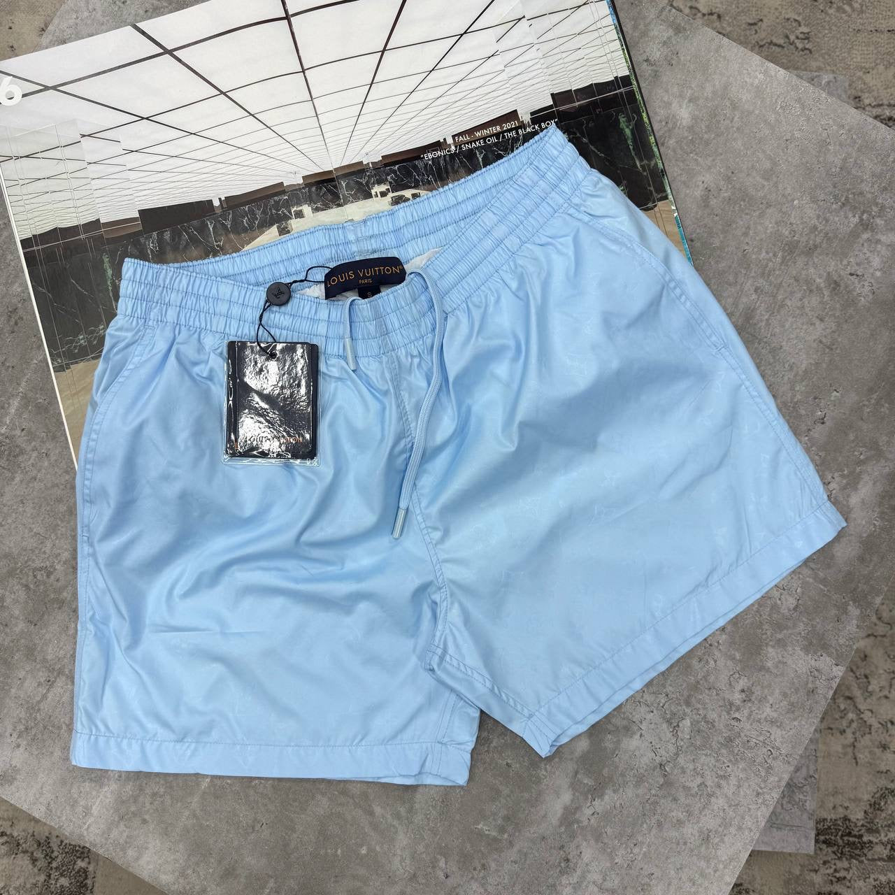 LVE MONOGRAM SWIM SHORTS - SKY BLUE